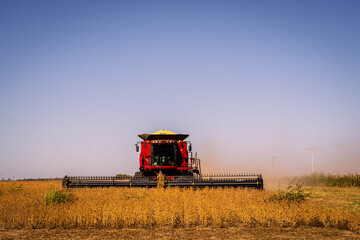 Plakat combine harvester working on a field