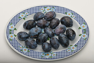 Fresh plums on plate