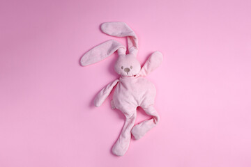top view of cute pink plush rabbit dancing on pink background with copy space - obrazy, fototapety, plakaty