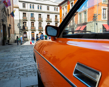 Orange classic car on the street