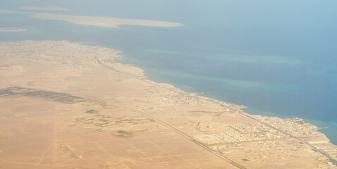 view from the plane window of the Red Sea and the desert in Egypt