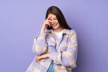 Teenager caucasian girl isolated on purple background laughing
