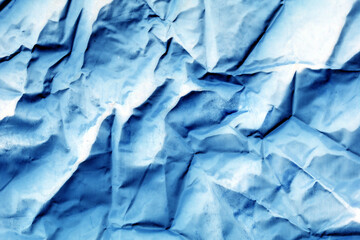 Abstract background with blue and white crumpled paper. Blue crumpled background. 