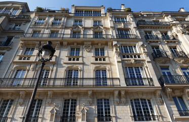 Traditional French house with typical balconies and windows. Paris.