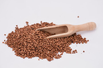 buckwheat on white findal and wooden spoon