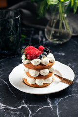 Gingerbread cake on a plate next to a cup of coffee