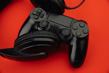 Black headphones and a gamepad close-up. Cybersport concept