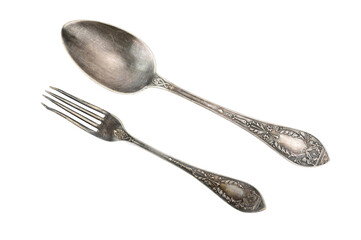 Top view of a tablespoon and fork with embossed patterns on the handles. Both are from one set