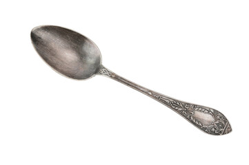 Top view of an old tablespoon with embossed patterns on the handle. The spoon lies diagonally across the image