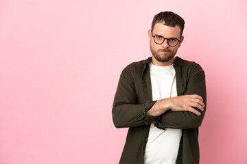 Young Brazilian man isolated on pink background feeling upset