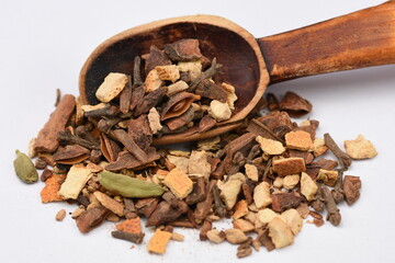 Mulled wine spice ingredients  and wooden spoon isolated on white background