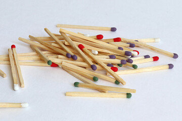 Scattered matches of different colors on a white background