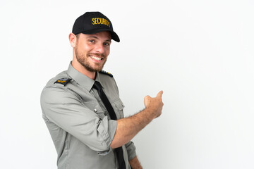 Young security Brazilian man isolated on white background pointing back
