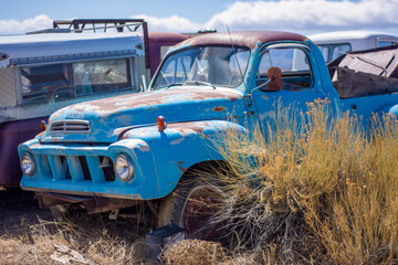 Blue truck in a junkyard - obrazy, fototapety, plakaty
