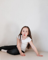 large portrait of a little girl showing her tongue.