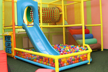 Maze and slide with balls in children's playroom, entertainment center