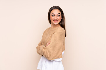 Obraz premium Young caucasian woman isolated on beige background with arms crossed and happy