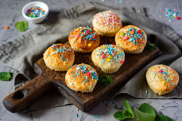 Sweet breakfast: cottage cheese cupcakes on a beautiful board on a gray background. Close-up