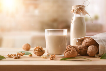 Glass of alternative vegetable drink of walnuts in rustic kitchen