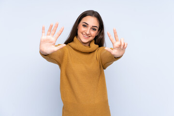 Young caucasian woman isolated on blue background counting eight with fingers