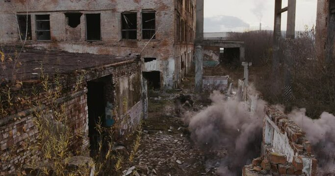 Group of military soldiers rescue the hostage, running past buildings that are bombarded by artillery or a mined area. Concept: war, explosions, acts of terrorism, doctrines. 4k Red 
