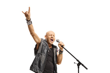 Rock star singing on a microphone and gesturing rock and roll sign