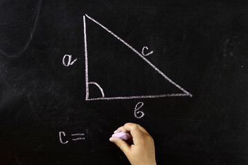 Maths, geometry formula written by chalk on the blackboard background