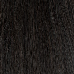 Human hair wig on a mannequin. Back view. Brunette. Straight hair