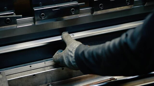 Working in production.Operator working on sheet metal cutting and bending, CNC bending machine in factory