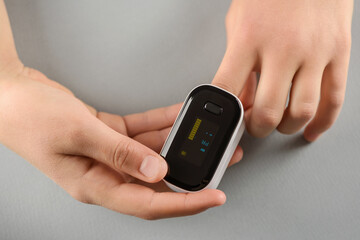 Measuring the amount of oxygen in blood with a pulse oximeter.