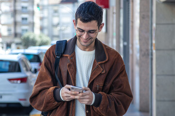 young man with mobile phone on the street