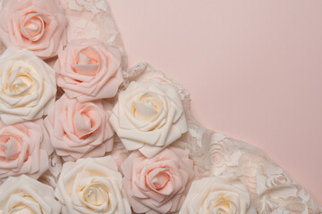 soft background of pale pink and white artificial roses and lace