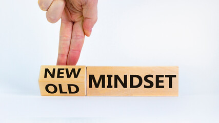 New vs old mindset symbol. Businessman turns the wooden block and changes words 'old mindset' to 'new mindset'. Beautiful white background. Business, new or old mindset concept. Copy space.