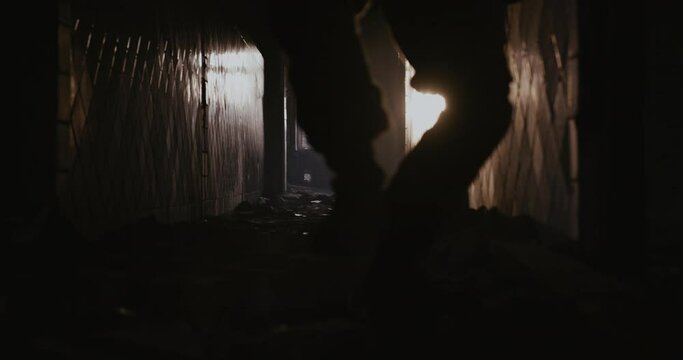 Soldier with a weapon runs along the corridor in search of a target to shoot.