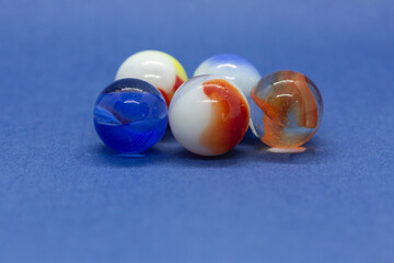 Assorted colors of marbles on a blue background 