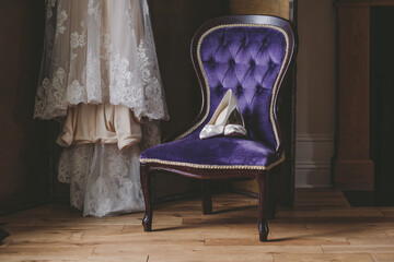 Bridal shoes displayed on a purple chair with dress, vintage