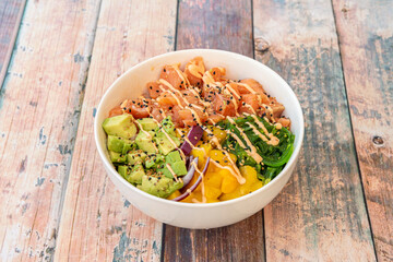 Salmon poke bowl in white bowl