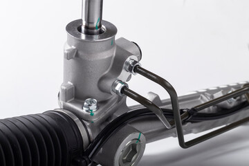 Obraz premium Studio lighting. on a white background, the steering rack of the car. New part.