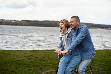 Couple on a bicycle walking