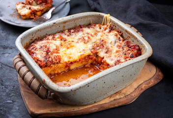 Modern style traditional Italian polenta alla sarda con salsiccia with ground meat ragu and pecorino served as top view on a ceramic backing form