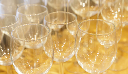  few radiant clean empty glasses stands on the table. selective focus. High quality photo