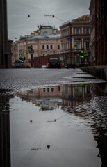 
roadway, cars, old houses, reflection in a puddle