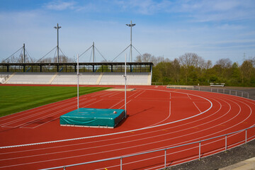 Part of sport stadium with running tracks and high jump area.
