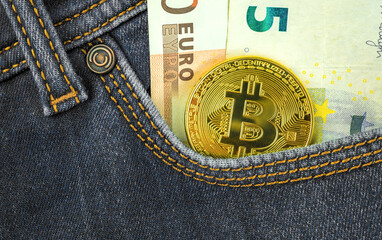 Digital currency money trading with bitcoin cryptocurrency concept, golden coin against euro money in pocket of denim jeans, close-up view