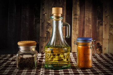 The set of peper, paprika and oil on a rustic wooden background.