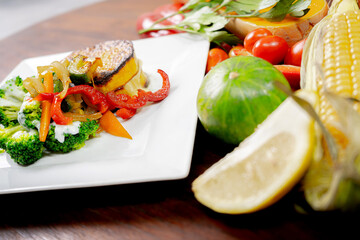 Healthy foods, full of vegetables and delicious flavors presented in white plate with colorful background