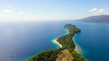 Big Liguid Island with beautiful beach, palm trees by turquoise water view from above. Big Cruz Island, Philippines, Samal.