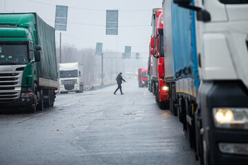 Naklejka premium a long traffic jam of many trucks at the border , a long wait for customs checks between States due to the coronavirus epidemic, increased sanitary inspection of cargo transport