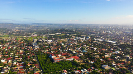Davao city with modern buildings, business centers on the island of Mindanao view from above. Davao del Sur, Philippines.