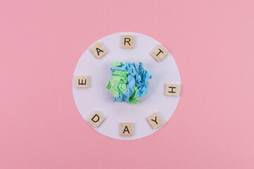 Creative paper earth on pink.